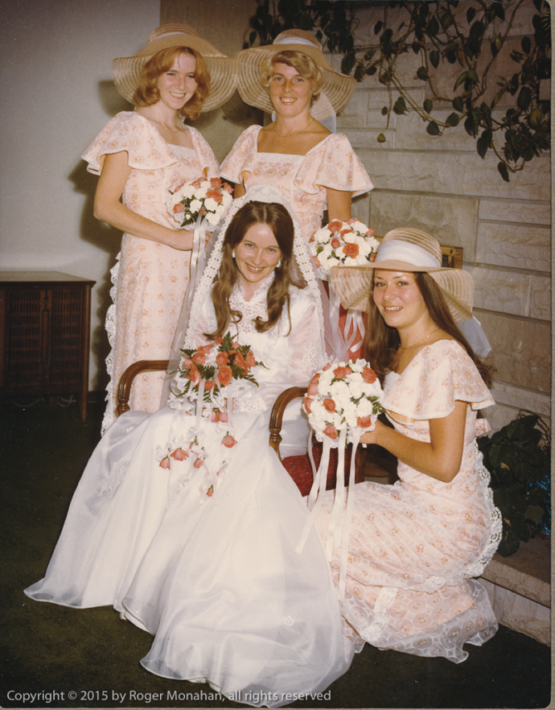 Bride seated, surrounded by bride's maids.