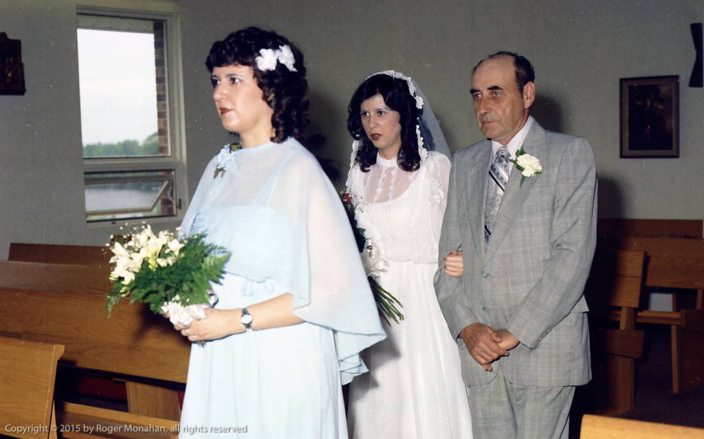 Maid of honor with bride and her father in procession.