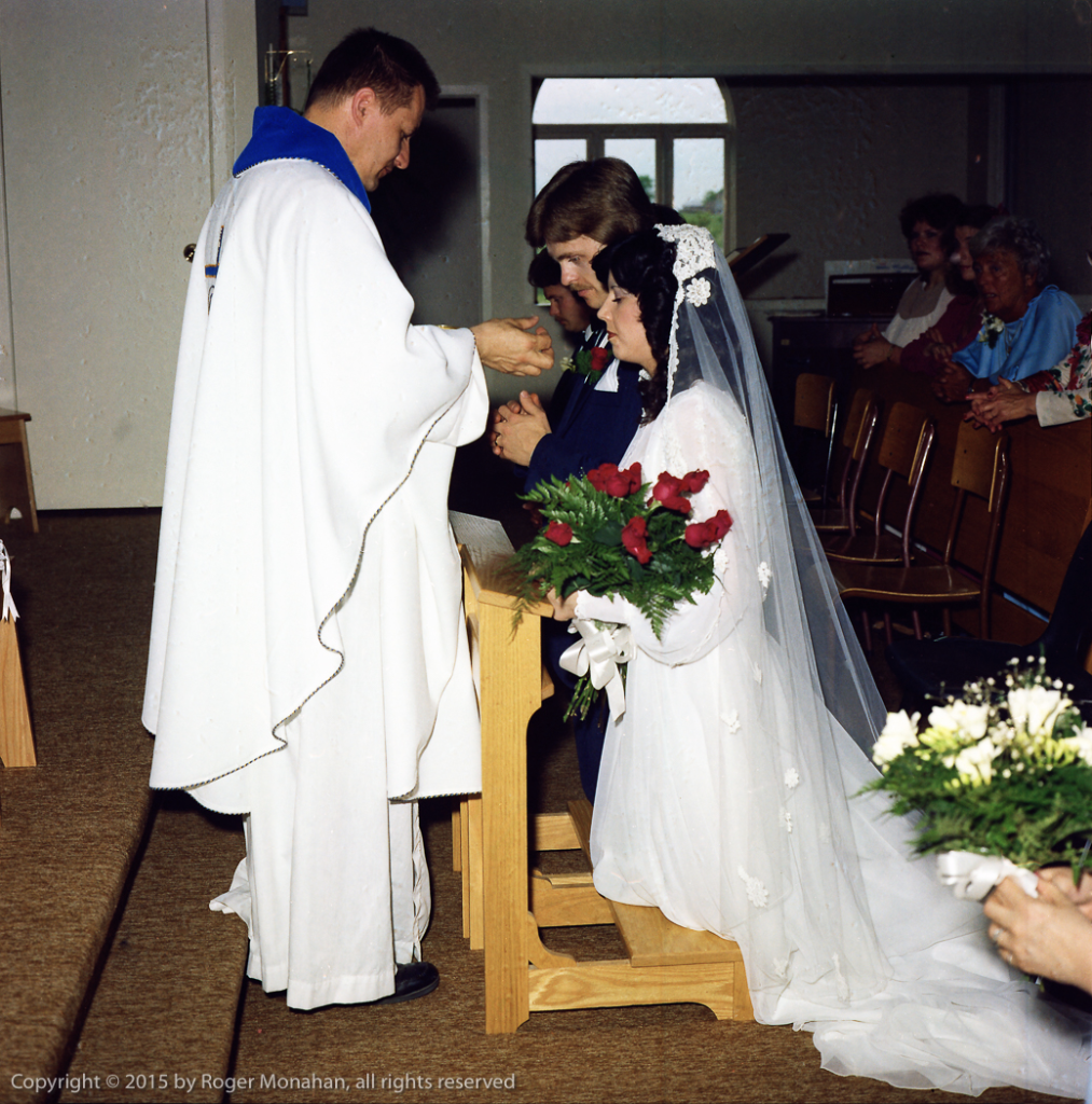 Bride and groom receiving communion.